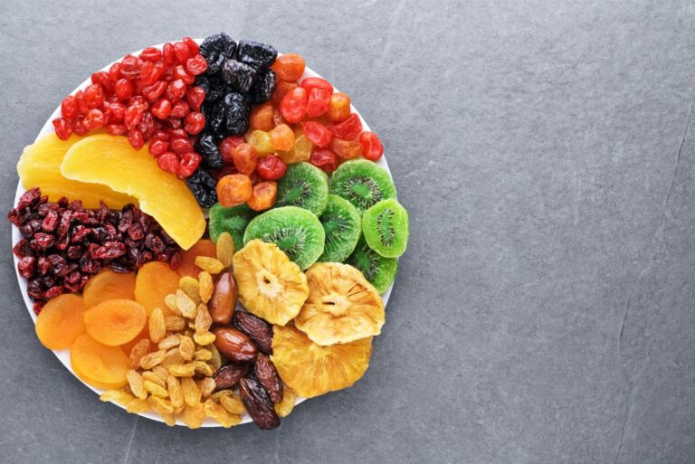 Bowl Full of Dried Fruits and Berries on a Gray Table